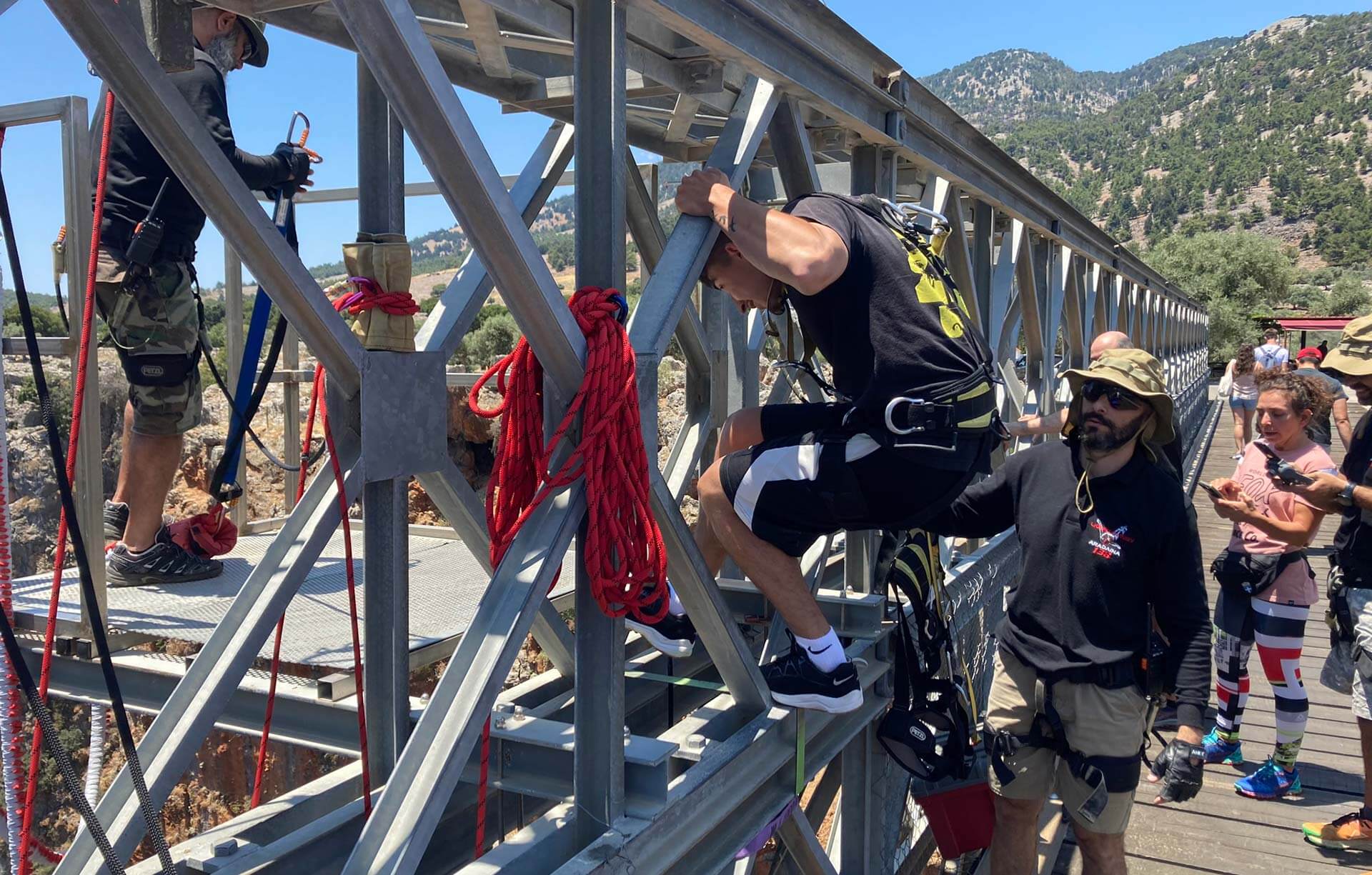 A group of people queuing to Bungee Jump off a Crete Bridge